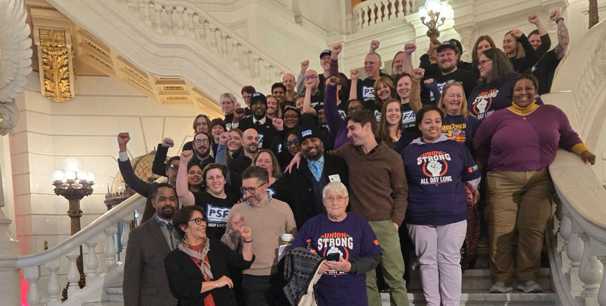 group on the stairs with fists raised